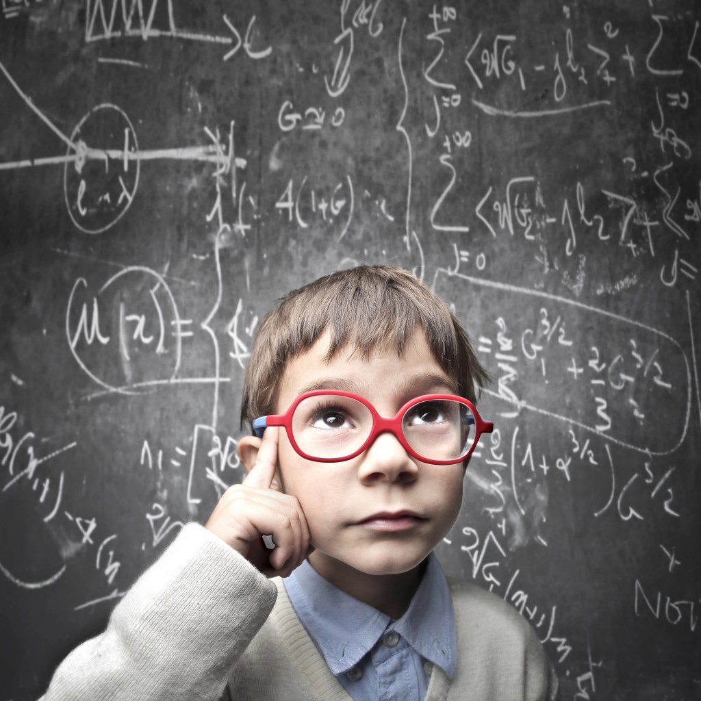 "A young child wearing red glasses and a sweater is looking up thoughtfully, with one finger on their temple. Behind them is a chalkboard filled with complex mathematical equations and diagrams."